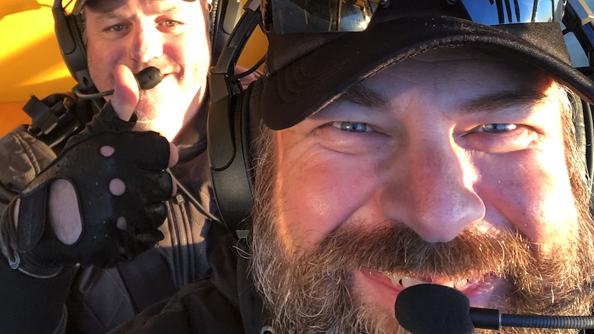 close up of two pilots in a plane