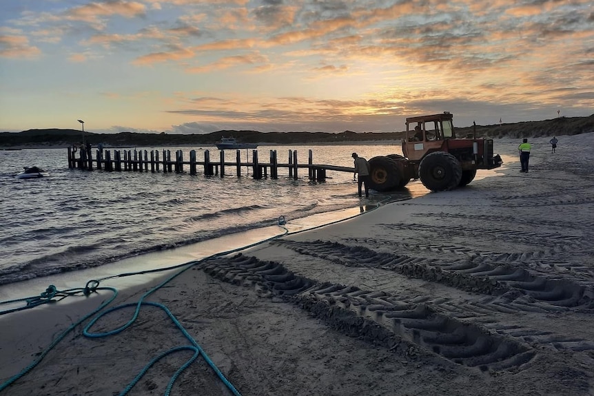 Image of a tractor pulling a fishing boat from the water