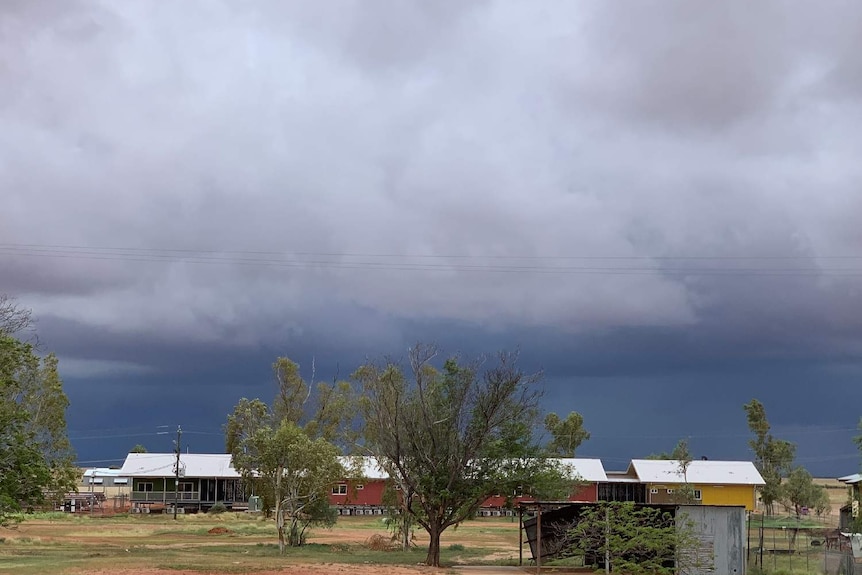 Dark rain clouds over an outback building.