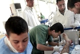A medic checks the leg of a wounded man at a medical centre in Misrata