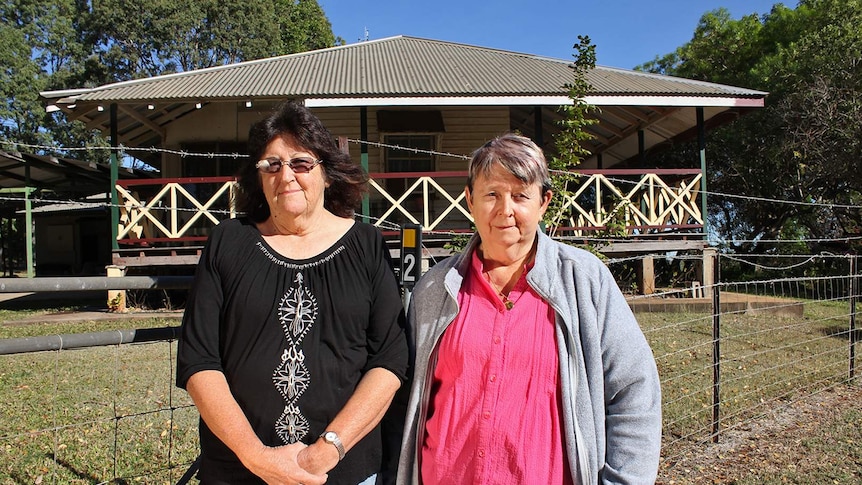 Two women stand in front of a cottage house in the town of Ravenswood north Queensland.