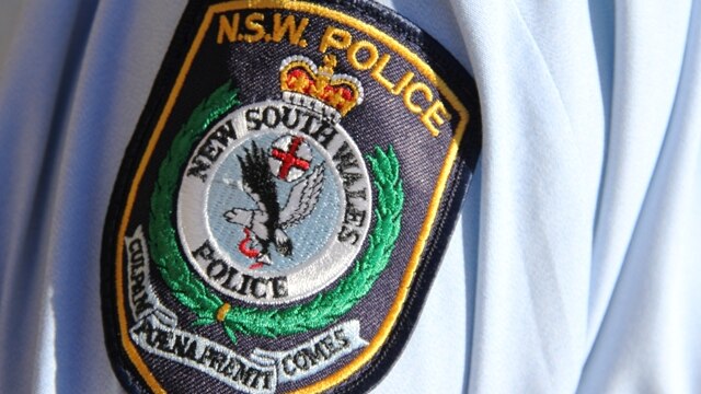 NSW police logo on uniform sleeve of policeman
