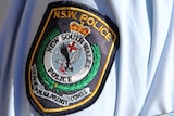 NSW police generic logo on uniform sleeve of policeman