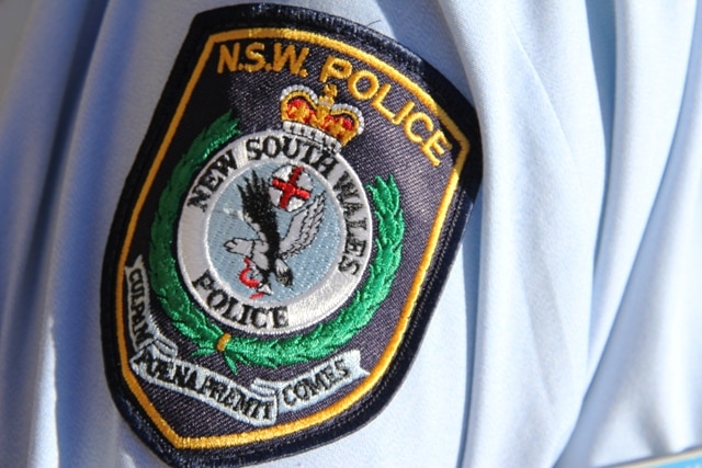 NSW police generic logo on uniform sleeve of policeman