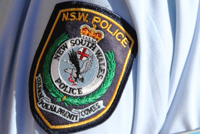 NSW police generic logo on uniform sleeve of policeman