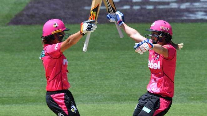 Sydney Sixers' Ashleigh Gardner and Ellyse Perry raise their bats celebrating a WBBL title win.