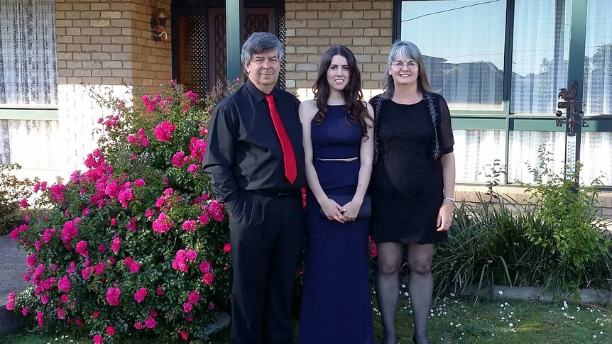 Cassie Godden with her parents on her graduation day.