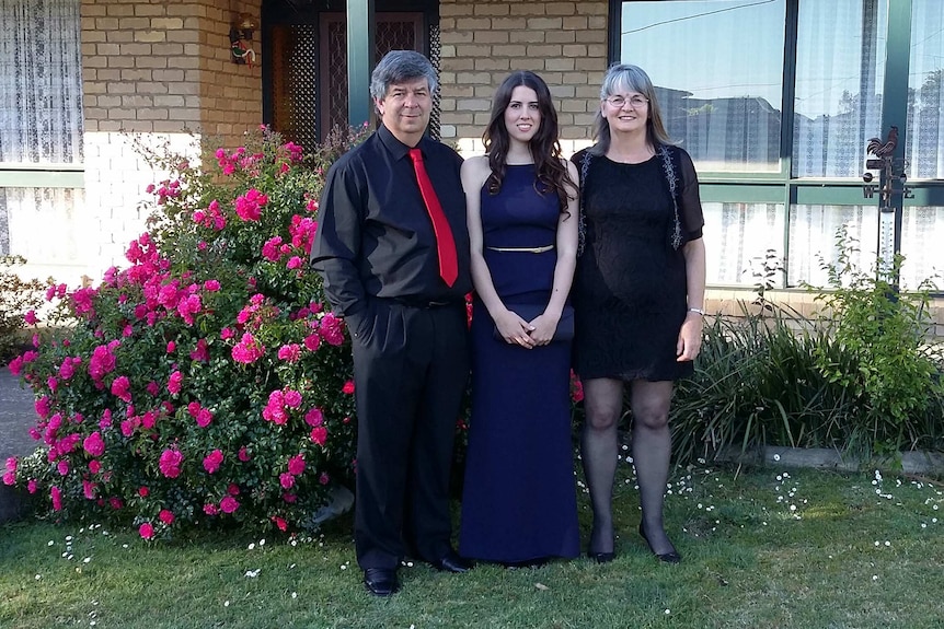 Cassie Godden with her parents on her graduation day.
