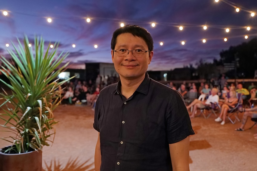 Dr Mark Cheung in front of some of lights at dusk