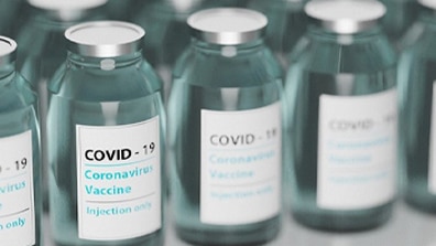 COVID-19 vials stand in a row ready to be administered.