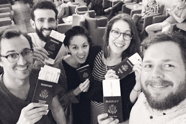 Kina Grannis with her touring party holding their passports.