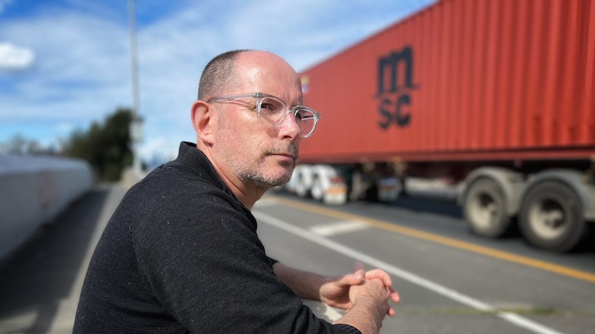 Martin Wurt watches as trucks travel through his neighbourhood.