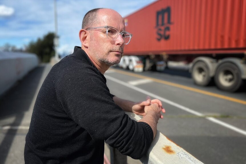 Martin Wurt watches as trucks travel through his neighbourhood.