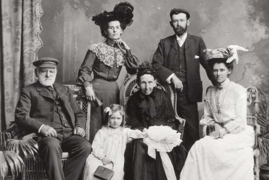 an old, black and white photo of six members of a family in fancy clothing