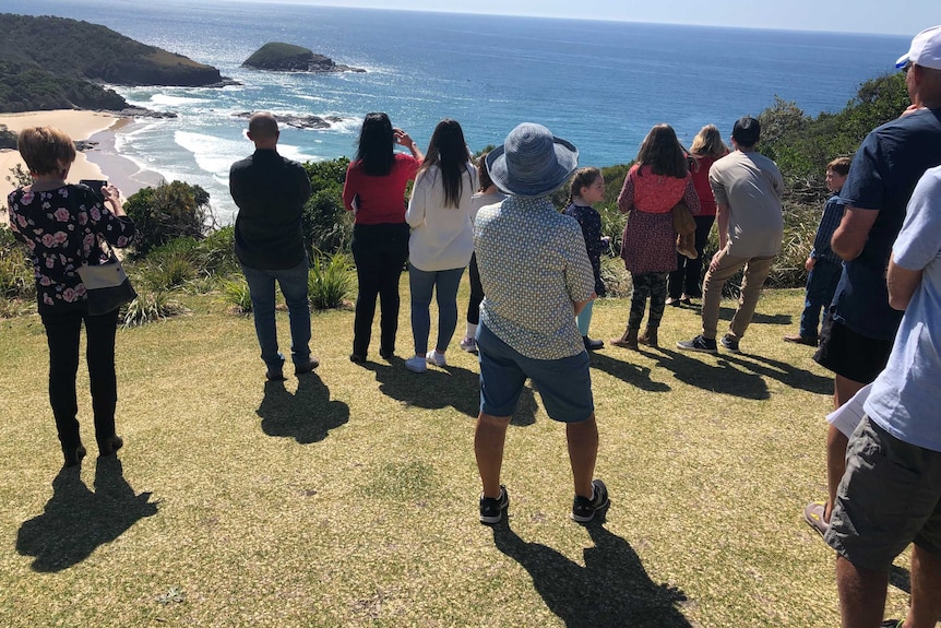 Families looking out to sea off Smoky Cape lighthouse where the MV Noongah sank