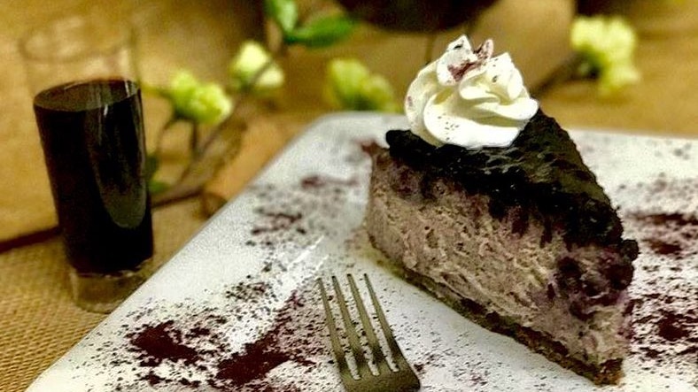 A slice of blueberry cheesecake made with cabernet sauvignon