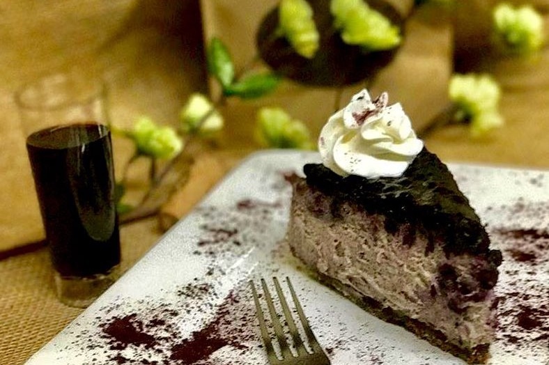 A slice of blueberry cheesecake made with cabernet sauvignon