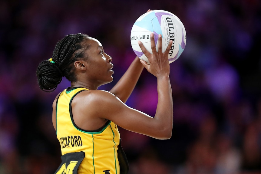 Jamaican netball player Shanice Beckford lines up a shot on goal at the Commonwealth Games.