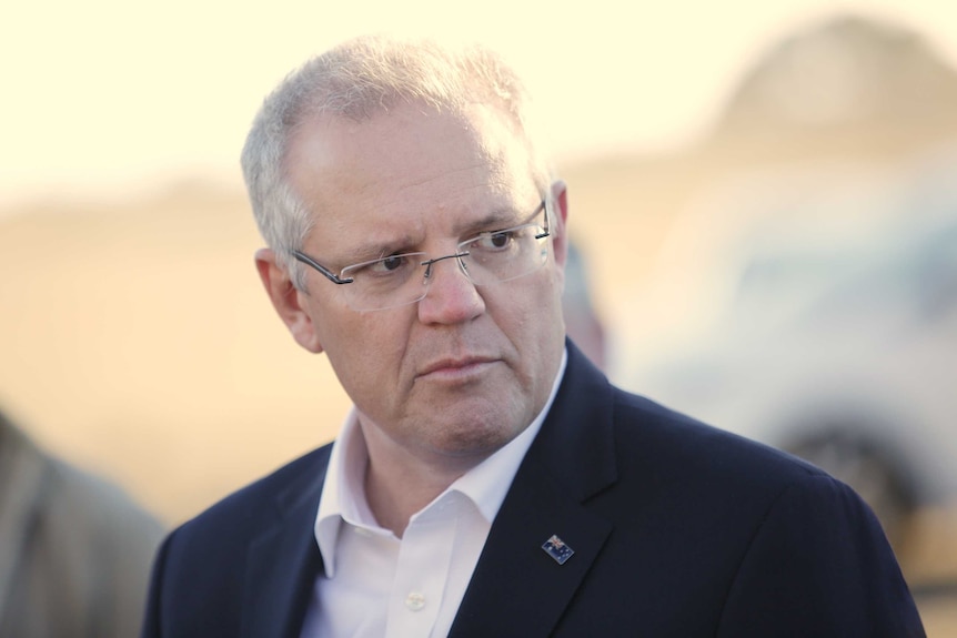 Prime Minister Scott Morrison glances at the media during a press conference