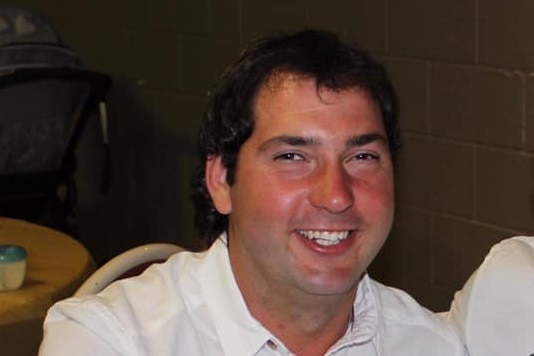 Truck driver Coen Fraser smiles at the camera.