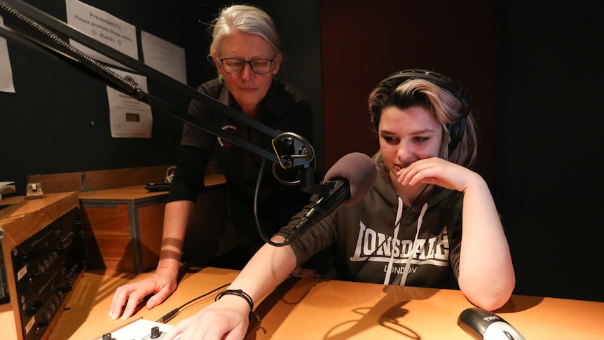 VCAL teacher Louise Olsen with Tiffany behind a radio panel.