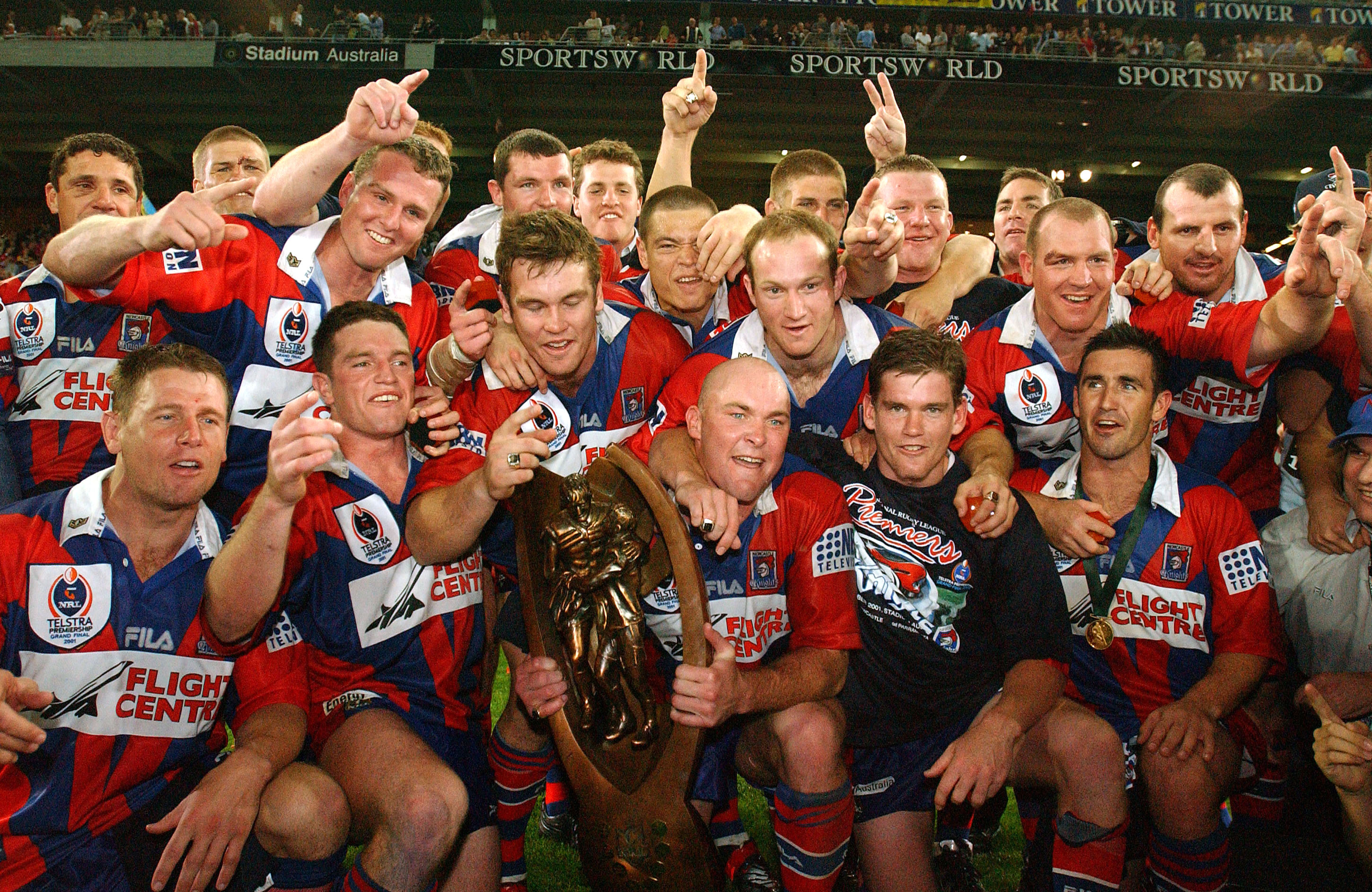 A rugby league team celebrates winning a grand final