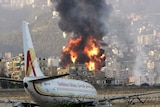 Fire rises from Beirut international airport after being attacked by Israeli aircraft.