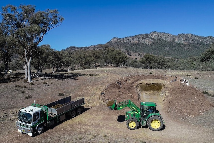 Wyatt Smith loads a truck with fodder.