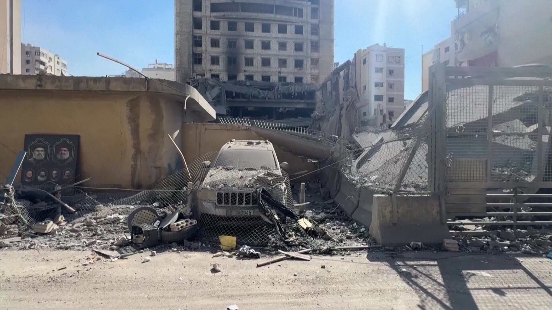 Smouldering wreckage of a building, car in Beirut's southern suburbs after Israeli strikes.