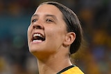 Sam Kerr pumps her right fist as she looks to the crowd after the Matildas defeated France.