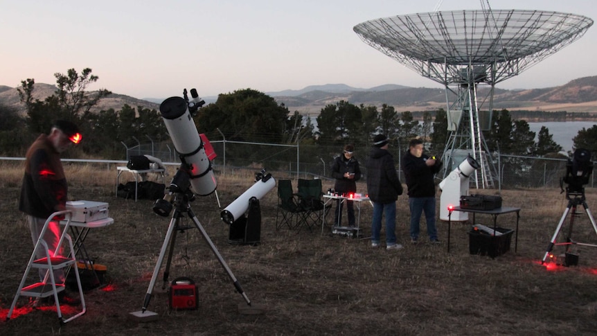 People setting up telescopes