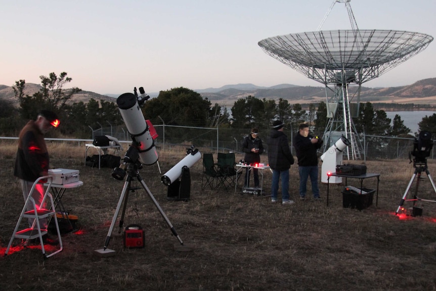 People setting up telescopes