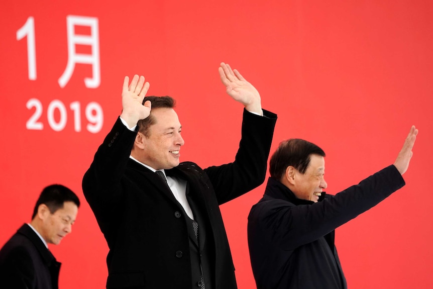 Elon Musk and Shanghai's mayor wave their arms around