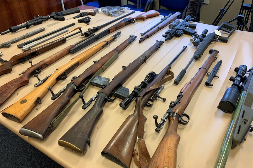 Guns seized by police on a table. 