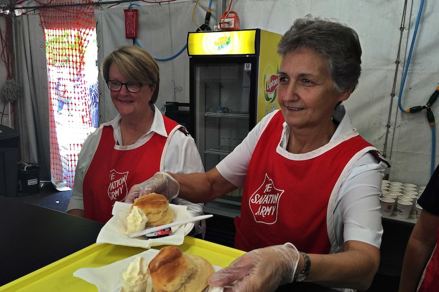 Captain Fran Everitt and Major Maree Strong hand out free scones at the Canberra Show.