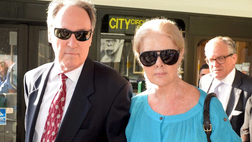 Robert Hughes, left, arrives at the Downing Centre Court in Sydney with his partner Robyn Gardiner.