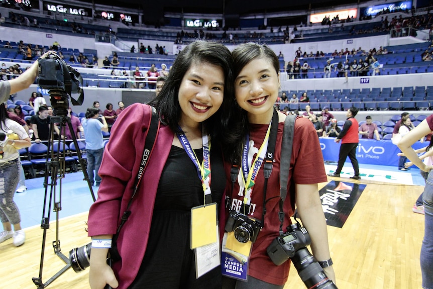 Two women in a basketball stadium