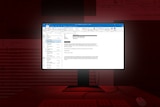 Graphic of computer on desk, the screen shows Microsoft Outlook email browser. Room background is dark red.