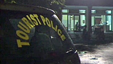 TV still of exterior of Bali police headquarters at night.