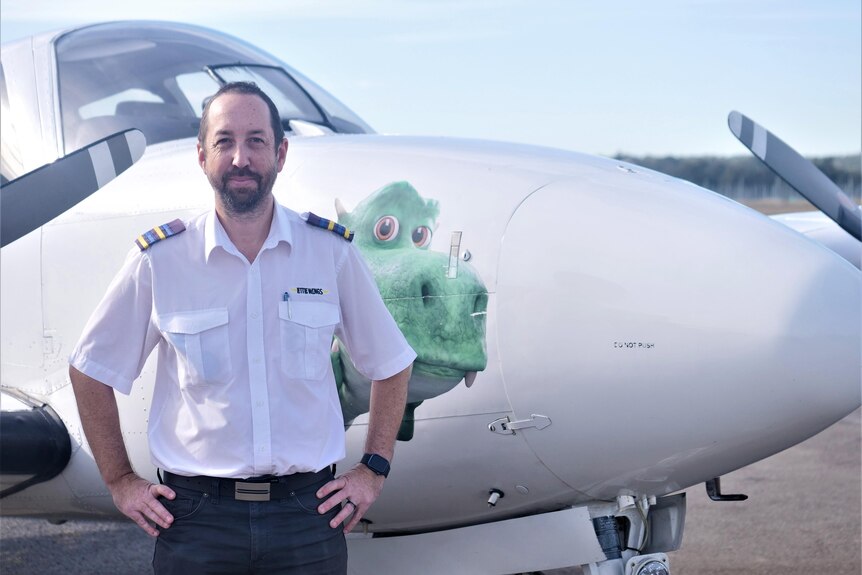 Paul Holt standing in front of a plane. 
