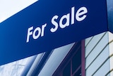 Close up of a sign advertising a house for sale in Brisbane.