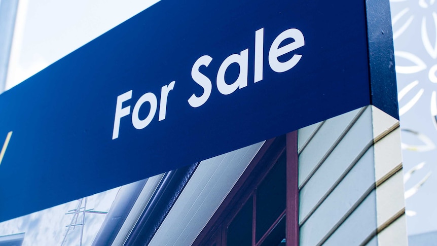 Close up of a sign advertising a house for sale in Brisbane.