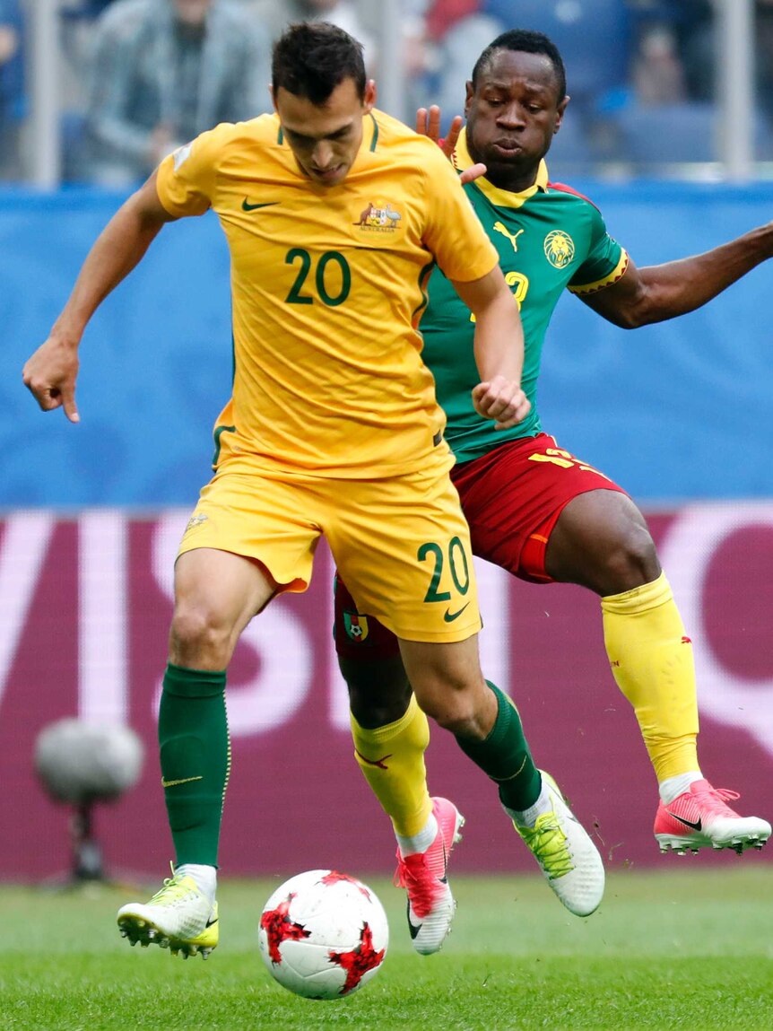 Australia's Trent Sainsbury is challenged by Cameroon's Christian Bassogog during the Confederations Cup.