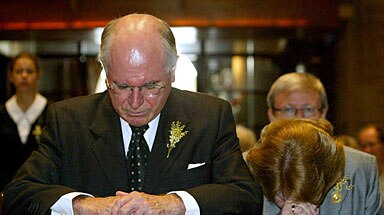 Lost in thought: Prime Minister John Howard and wife Janette pray for tsunami victims