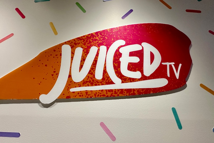 A wall mural that says "Juiced TV".