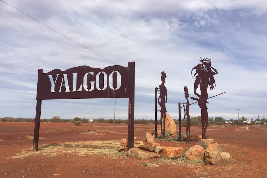 Yalgoo sign with cutout steel figures of Aboriginal men