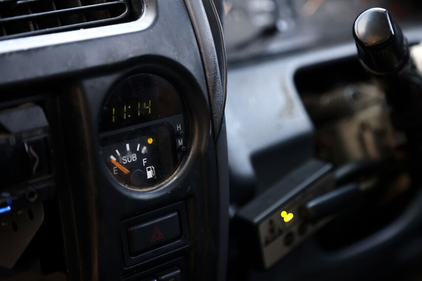 A fuel gauge in a car, with the needle resting on 'empty'.