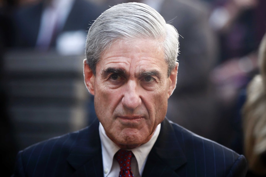Robert Mueller looks ahead with a stern expression.