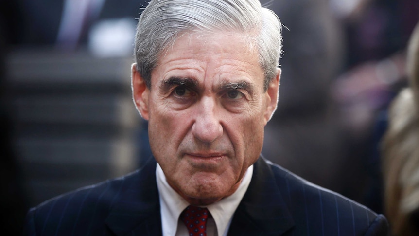 Robert Mueller looks ahead with a stern expression.