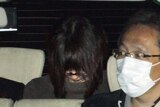 Aum cult member Naoko Kikuchi in the back of a police car.